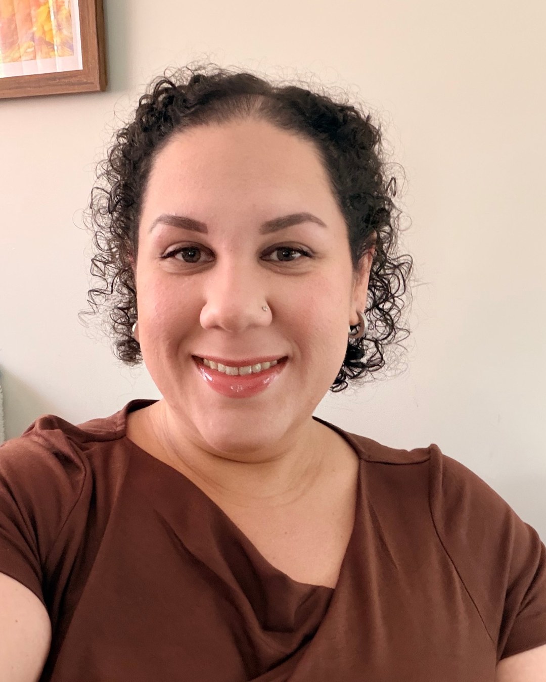 Camille M. Galanis, smiling, at home
